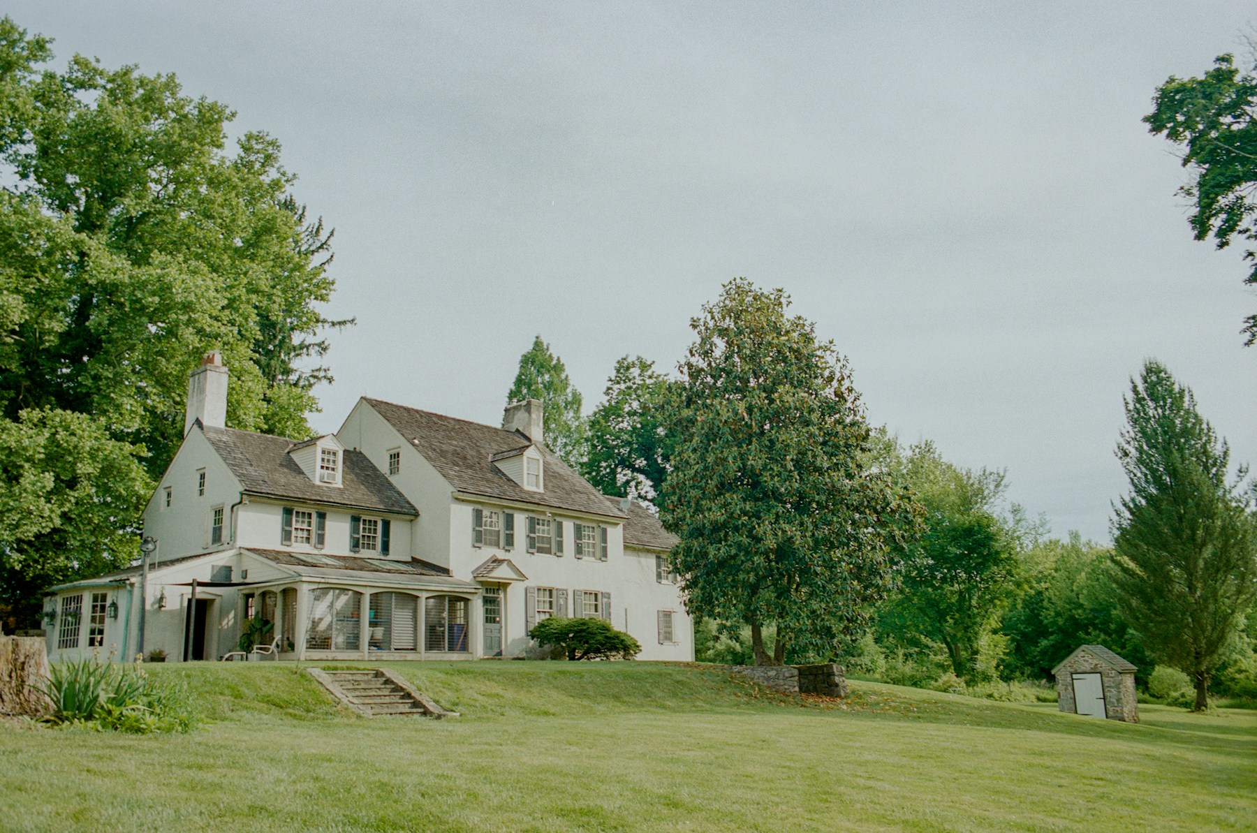 Welcoming residential home surrounded by trees and a green lawn